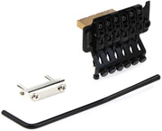 Black guitar tremolo bridge assembly - front angled view with mounting hardware and adjustment wrench