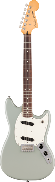 Fender electric guitar with a silver body and brown neck on a green background